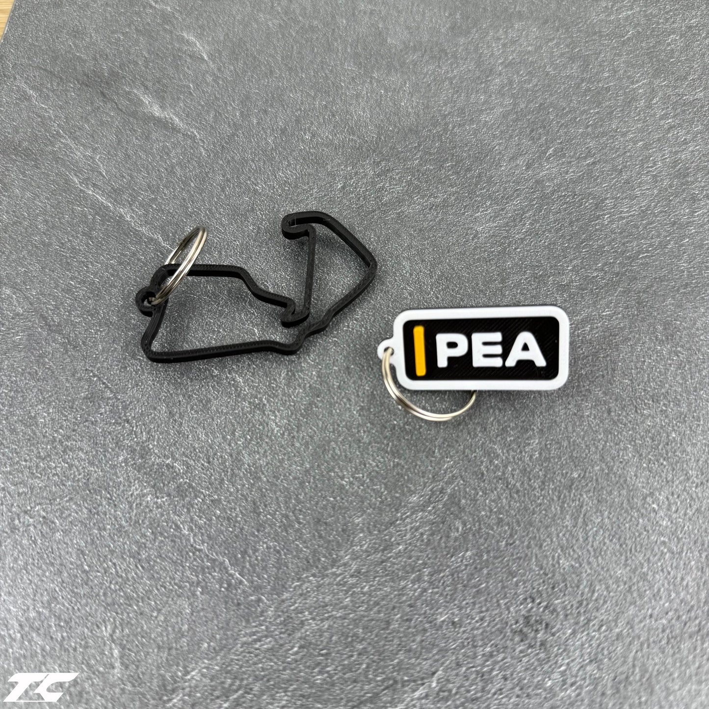 F1 The Movie Keychain Set – Driver Tag + Circuit Track | Sonny Hayes or Joshua Pearce
